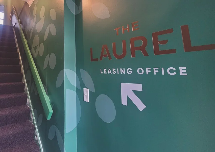An image of the interior wayfinding signage for The Laurel Leasing Office.
